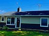 A house with a lawn and a blue sky